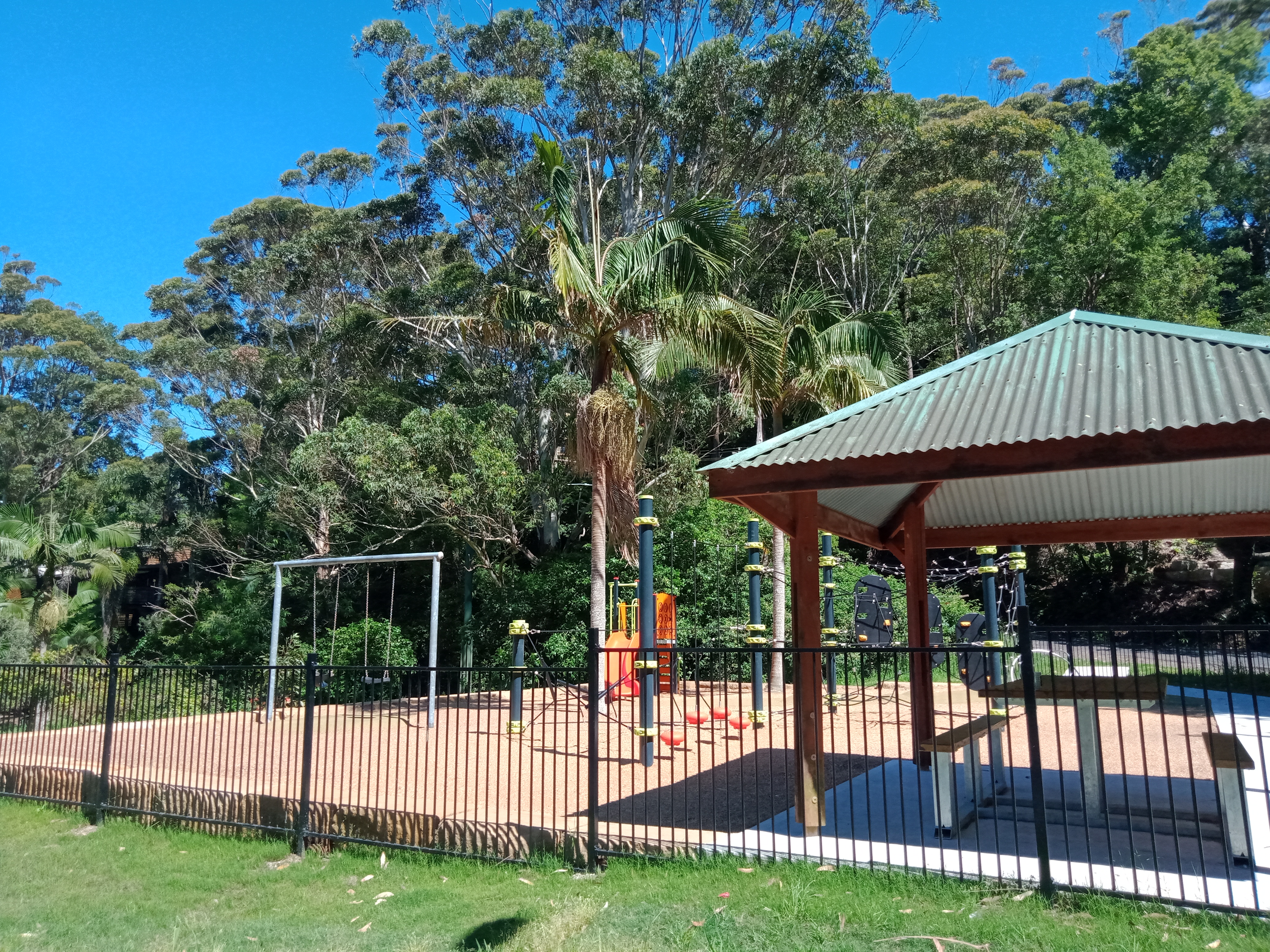 playspace with swings, shelter and table