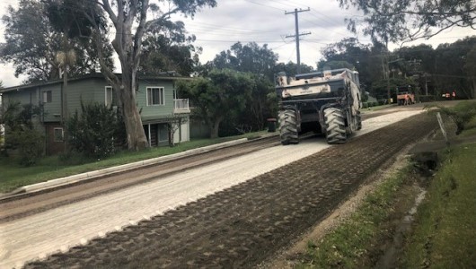 road renewal works with heavy machinery on residential street 