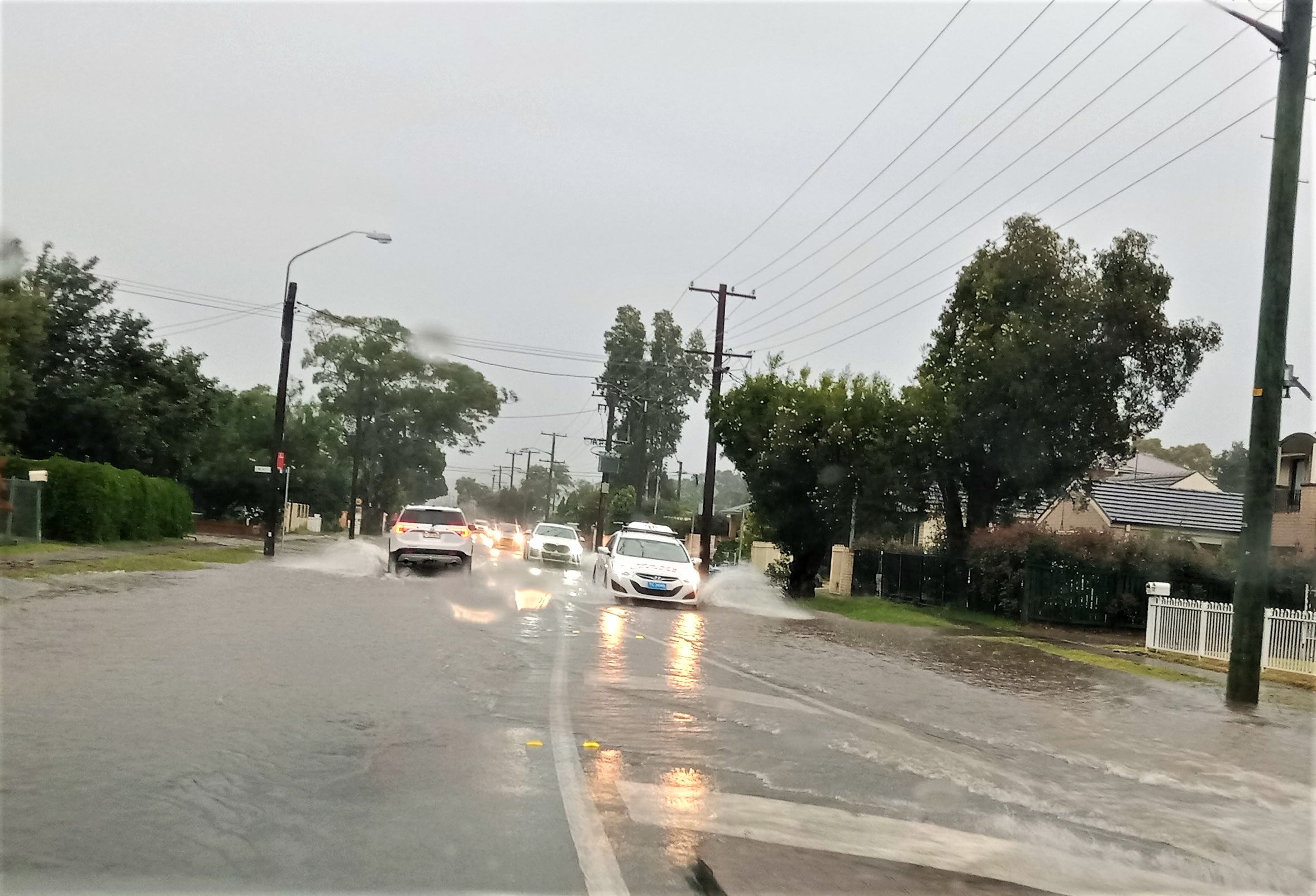 flash flooding over road with cars