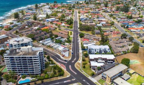 aerial photo showing road intersection with ocean in background