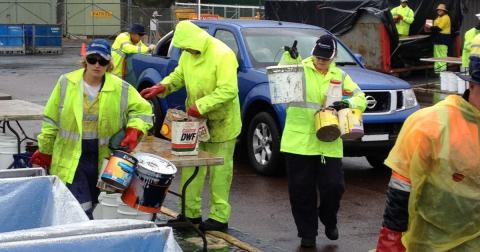 HIGH VIS WORKERS CARRYING CHEMICAL OUTSIDE